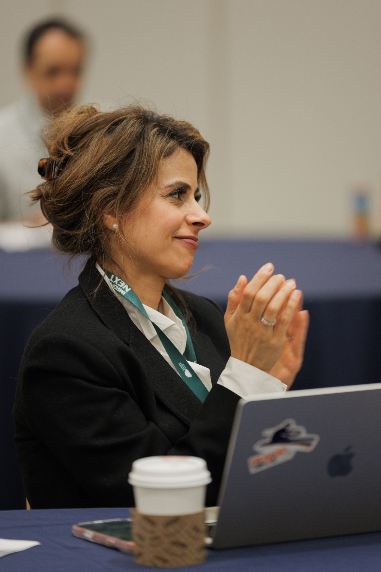 Mariam Amin JantzSell applauding from the audience during a Capital Day session