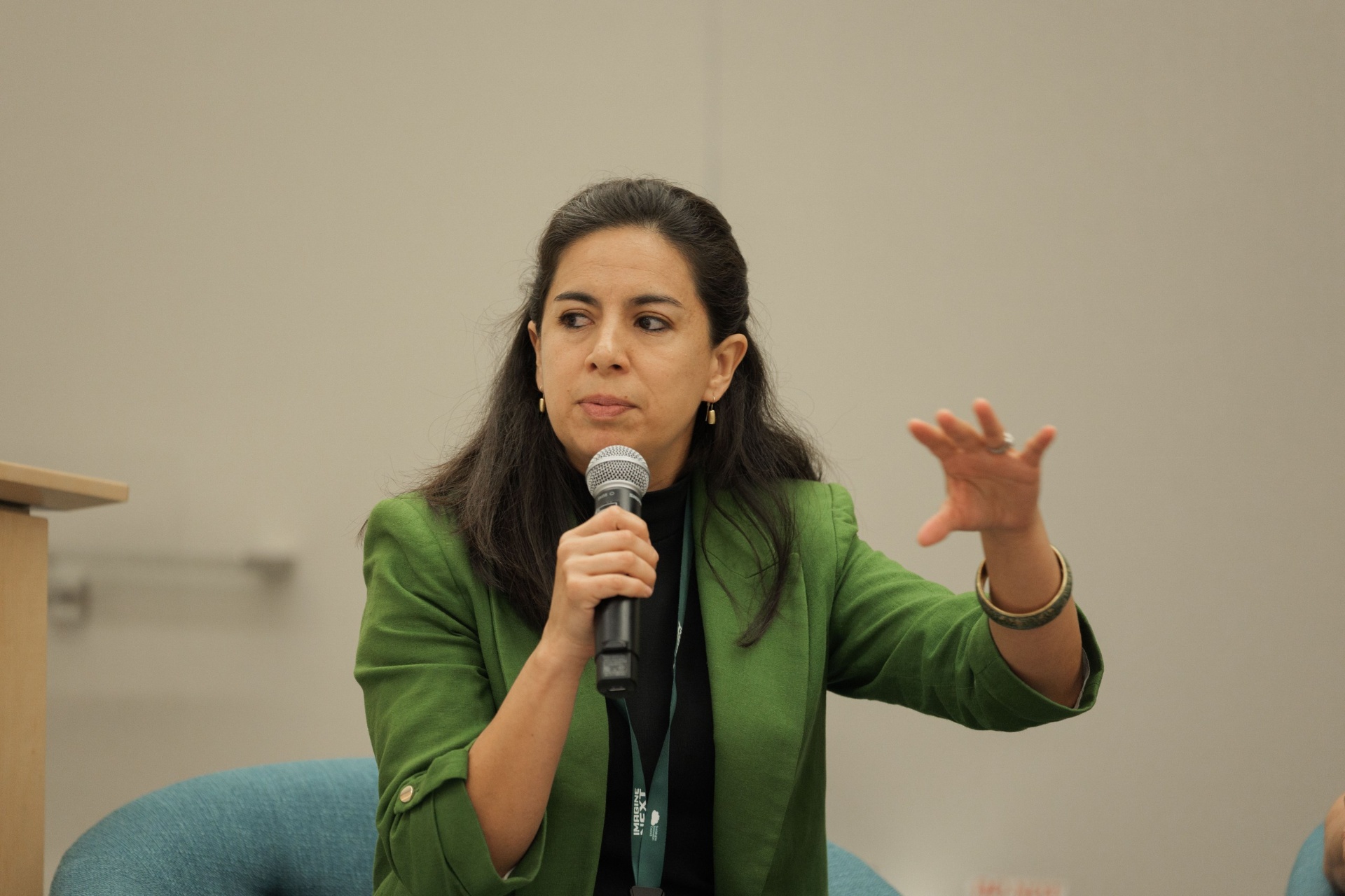 Capital Day moderator gesturing while guiding the panel discussion at UC Law SF
