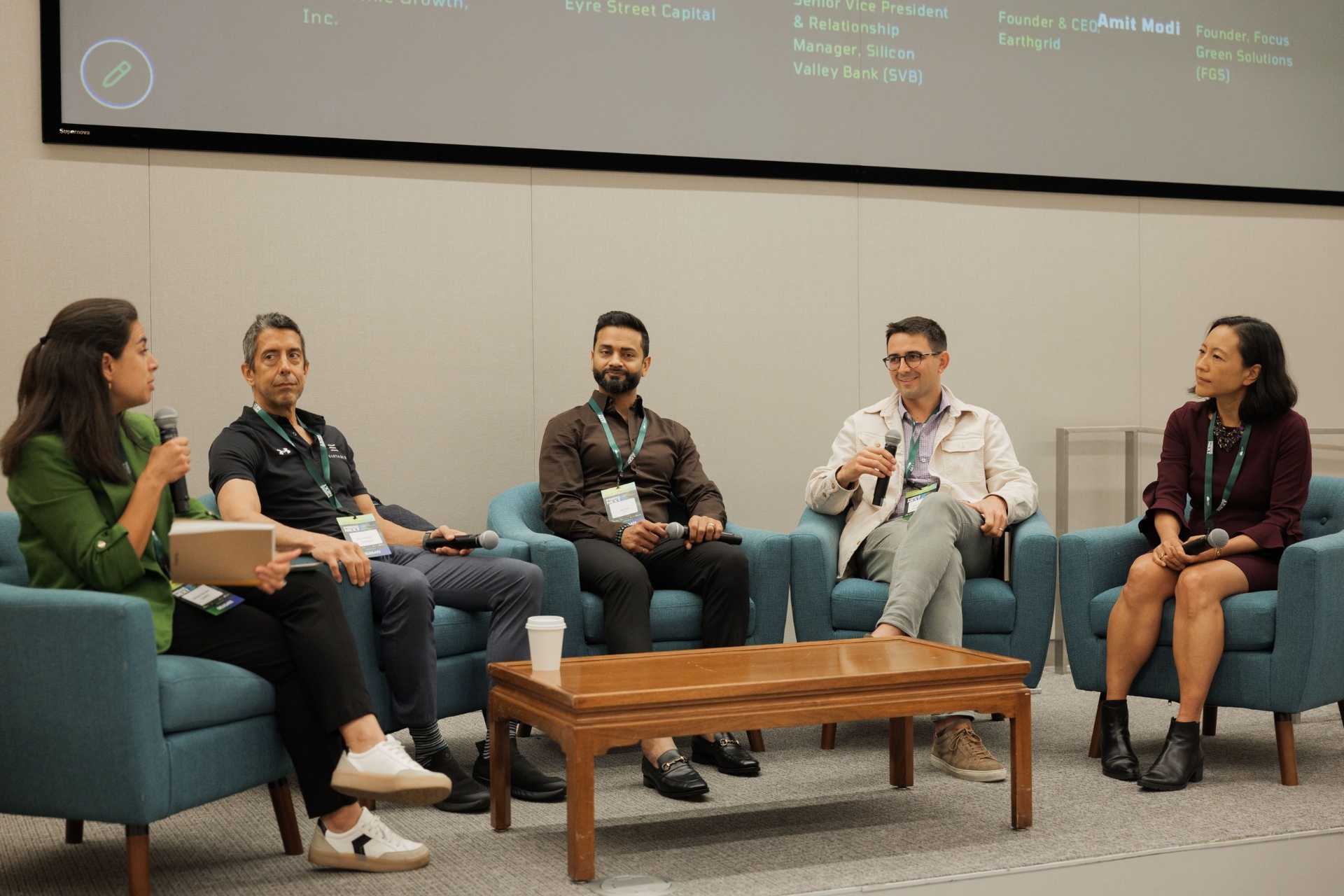 Capital Day founders and capital allocators panel of five at UC Law SF — moderator in green blazer leading the discussion