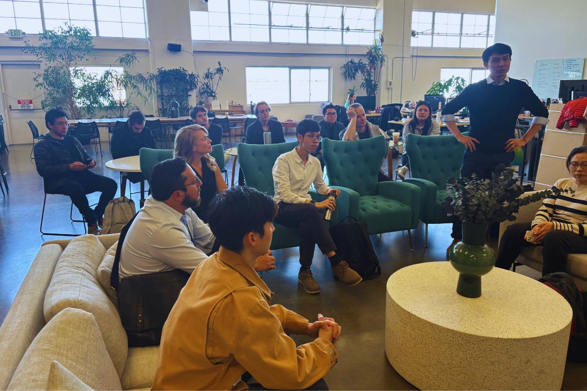 SOSV team member standing and presenting to founders and investors seated across teal armchairs during the Frontiers Day session