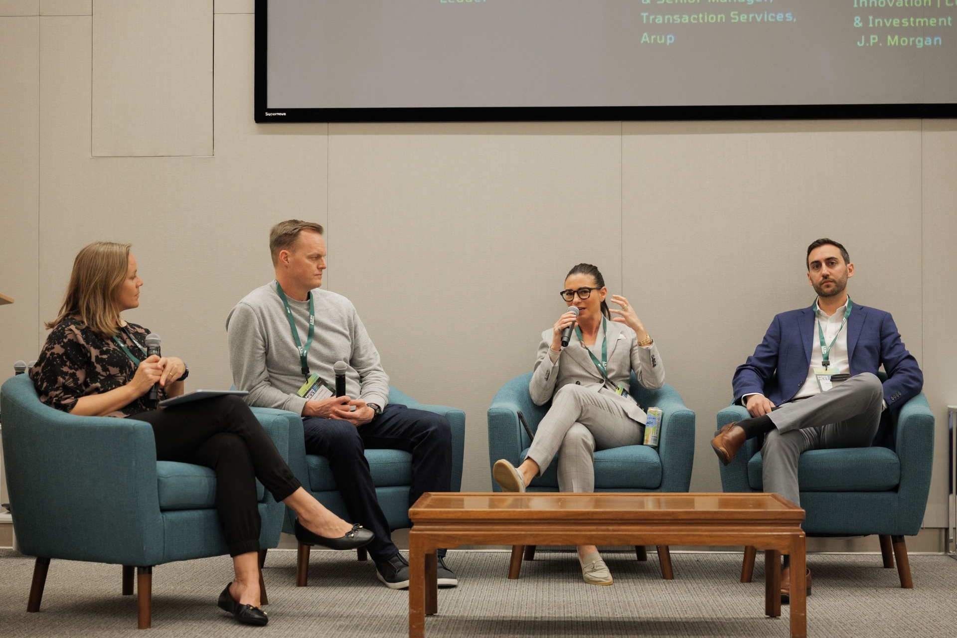 Capital Day Panel 5 'From Growth to Bankability: What Downstream Capital Requires' at UC Law SF with moderator Christina Cairns, Dr. Tobi Ann Petrocelli of Arup and Daniel Baruch of J.P. Morgan on stage beneath the speaker line-up slide