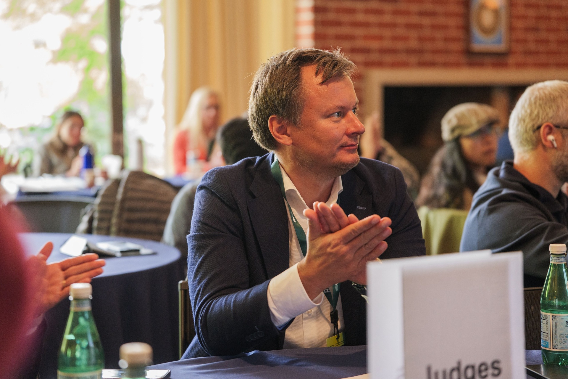 Judge applauding at the Judges table during pitch session