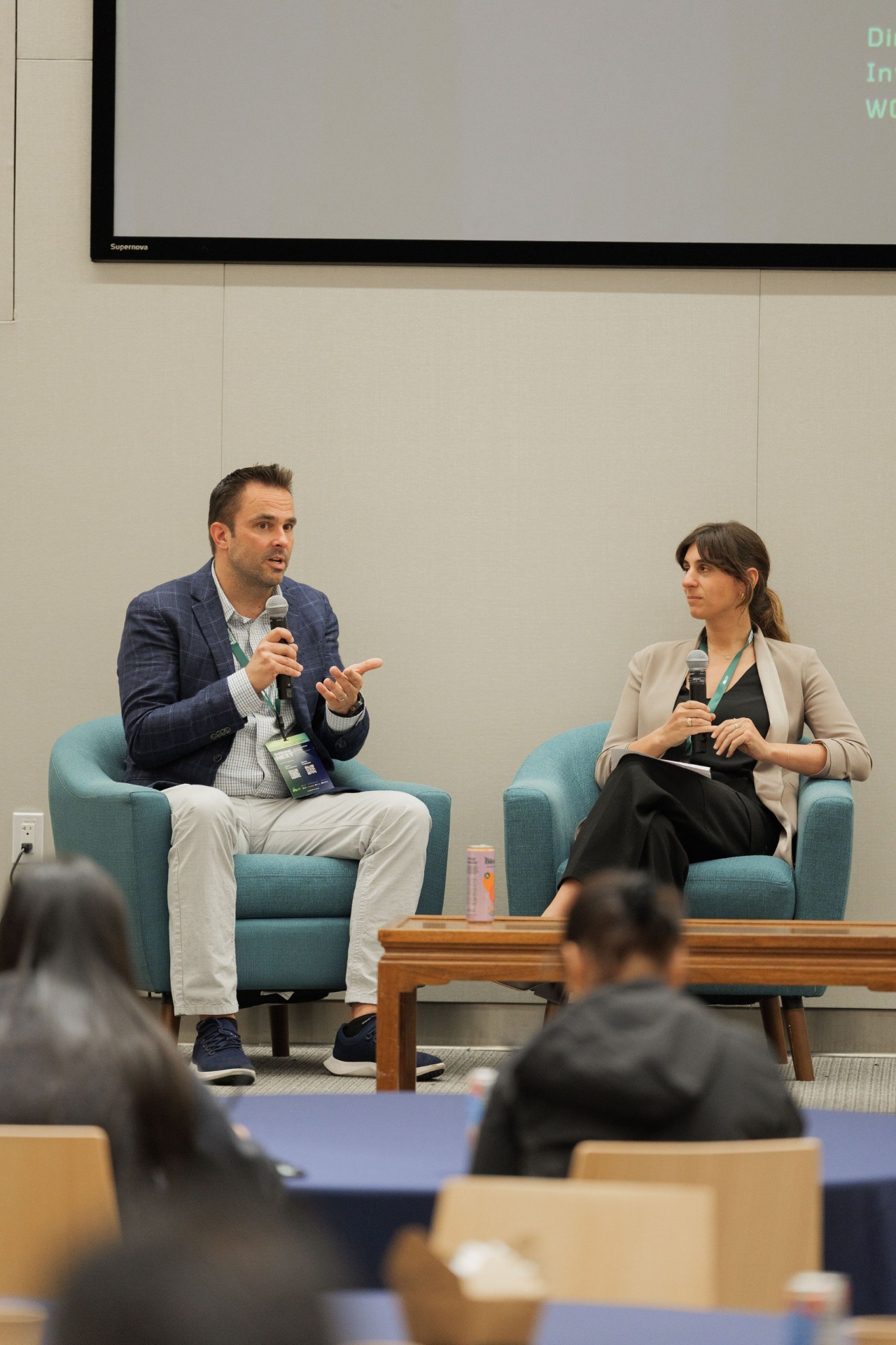 Dr. Ryan Gilliam, CEO of Fortera, speaking with mic while moderator Natalie Volpe of WOLLEMI listens during the Capital Day fireside chat on crossing the deployment valley