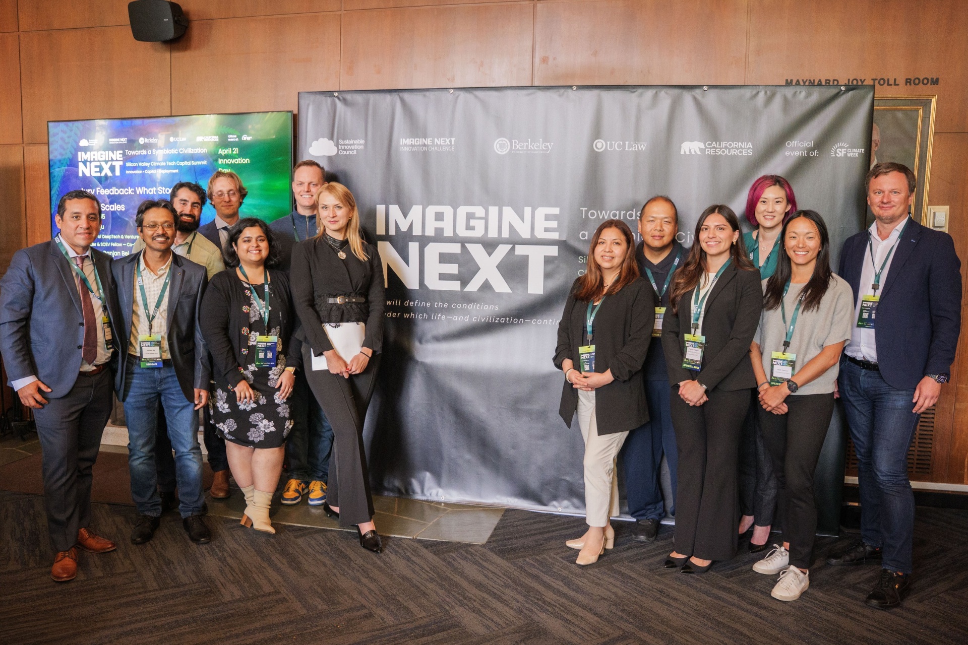 Jury and team posing in front of the Imagine Next backdrop