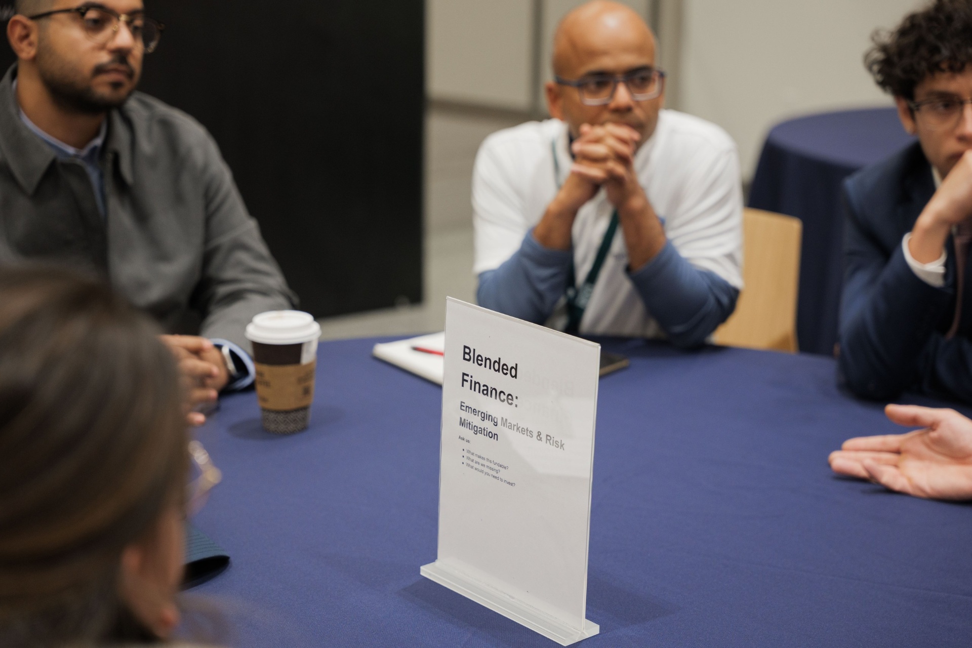 Capital Day Curated Capital Matchmaking Session table sign — 'Blended Finance: Emerging Markets & Risk Mitigation' with delegates listening at UC Law SF